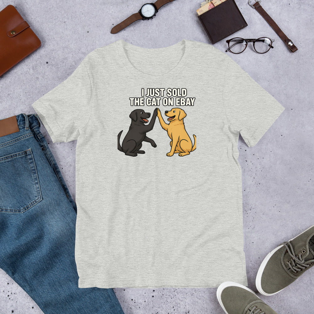 "I Just Sold The Cat On eBay" - Fun Labrador T-Shirt Gray t-shirt with cartoon dogs and text on a gray surface with jeans, shoes, and accessories.