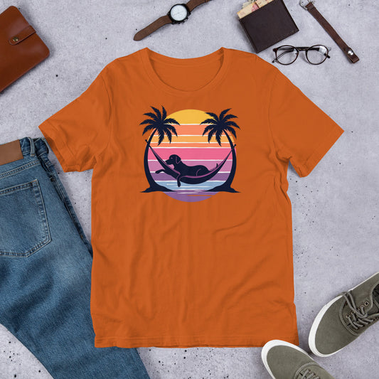 "Labrador In Paradise " – Fun Labrador T-Shirt Orange t-shirt with a mermaid and palm tree design on a concrete surface with jeans, shoes, and accessories.