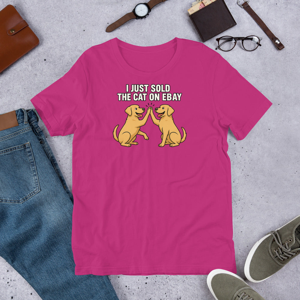 "I Just Sold The Cat On eBay" - Fun Labrador Pink t-shirt with dog graphic and text on a gray surface with casual items.