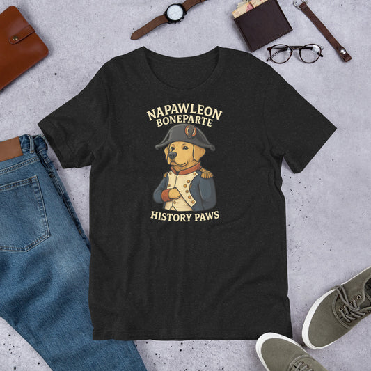 "Napawleon Boneparte" -Fun Labrador T-Shirt Black t-shirt with a dog in a Napoleon costume graphic and text 'Napawleom Bonaparte History Paws' on a concrete surface with jeans, shoes, and accessories.
