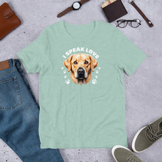 "I Speak Love" - Fun Labrador T-Shirt Mint green t-shirt with a dog graphic and 'I Speak Love' text, placed on a concrete surface with jeans, shoes, and accessories.