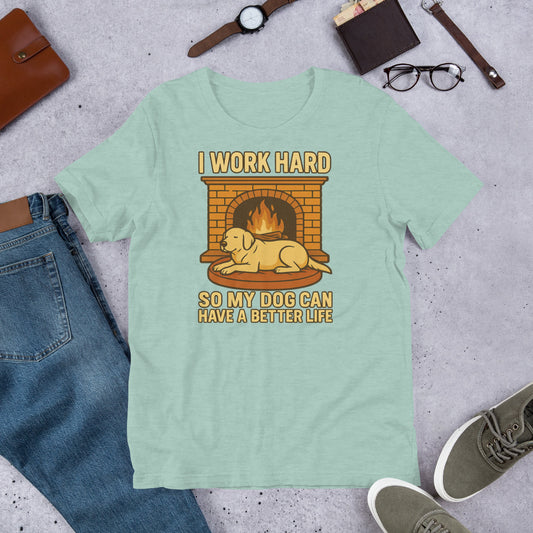 "I Work Hard So My Dog Can Have A Better Life " - Fun Labrador T-Shirt Light green t-shirt with a graphic of a dog by a fireplace and text 'I work hard so my dog can have a better life' on a concrete surface with jeans, shoes, and a wallet.