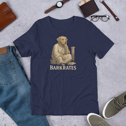 "Barkrates" - Fun Labrador T-Shirt Navy blue t-shirt with a graphic of a dog and text 'BARKRATES' on a concrete surface with casual items.