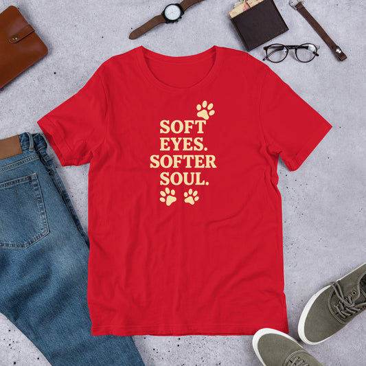 "Soft Eyes Softer Soul" - Fun Labrador T-Shirt Red t-shirt with 'Soft Eyes. Softer Soul.' text on a gray surface with jeans, shoes, and accessories.
