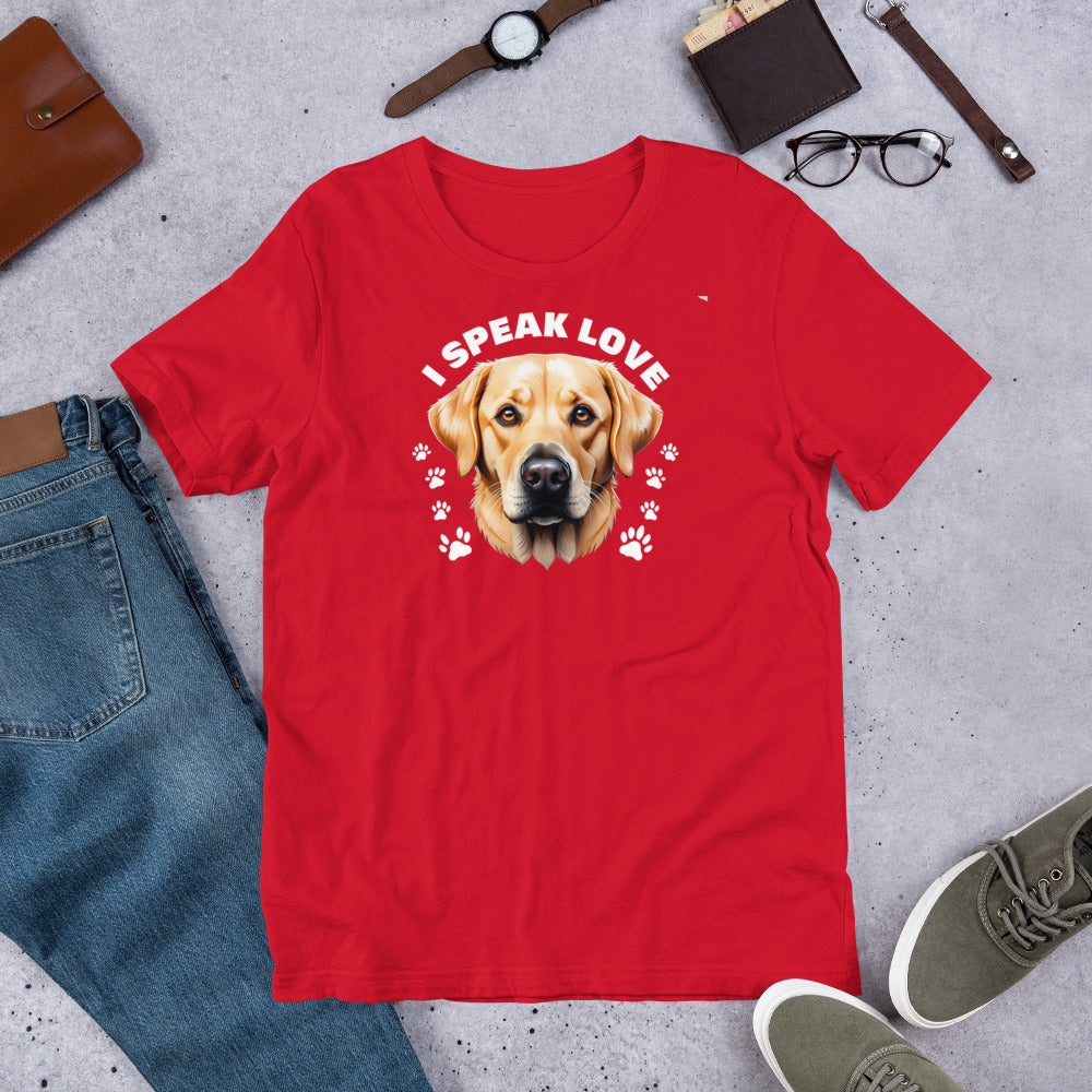 "I Speak Love" - Fun Labrador T-Shirt Red t-shirt with a dog graphic and 'I Speak Love' text, surrounded by casual items on a concrete surface.
