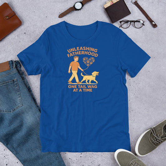 "Unleashing Fatherhood " – Fun Labrador T-Shirt Blue t-shirt with graphic design and text on a concrete surface with jeans, shoes, and accessories.