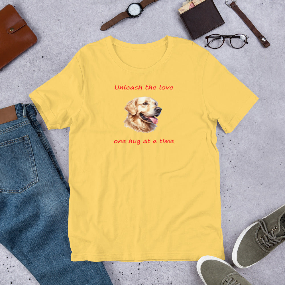"Unleash The Love" - Funny Labrador T-Shirt Yellow t-shirt with a dog graphic and text on a gray surface with jeans, shoes, and accessories.