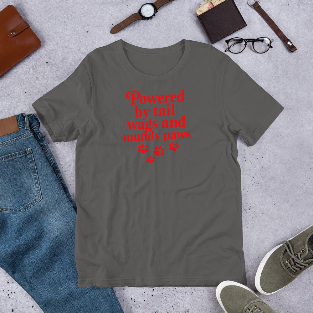 "Powered By Tail Wags And Muddy Paws" - Fun Labrador T-Shirt  Gray t-shirt with red text and paw prints on a concrete surface with jeans, shoes, and accessories.