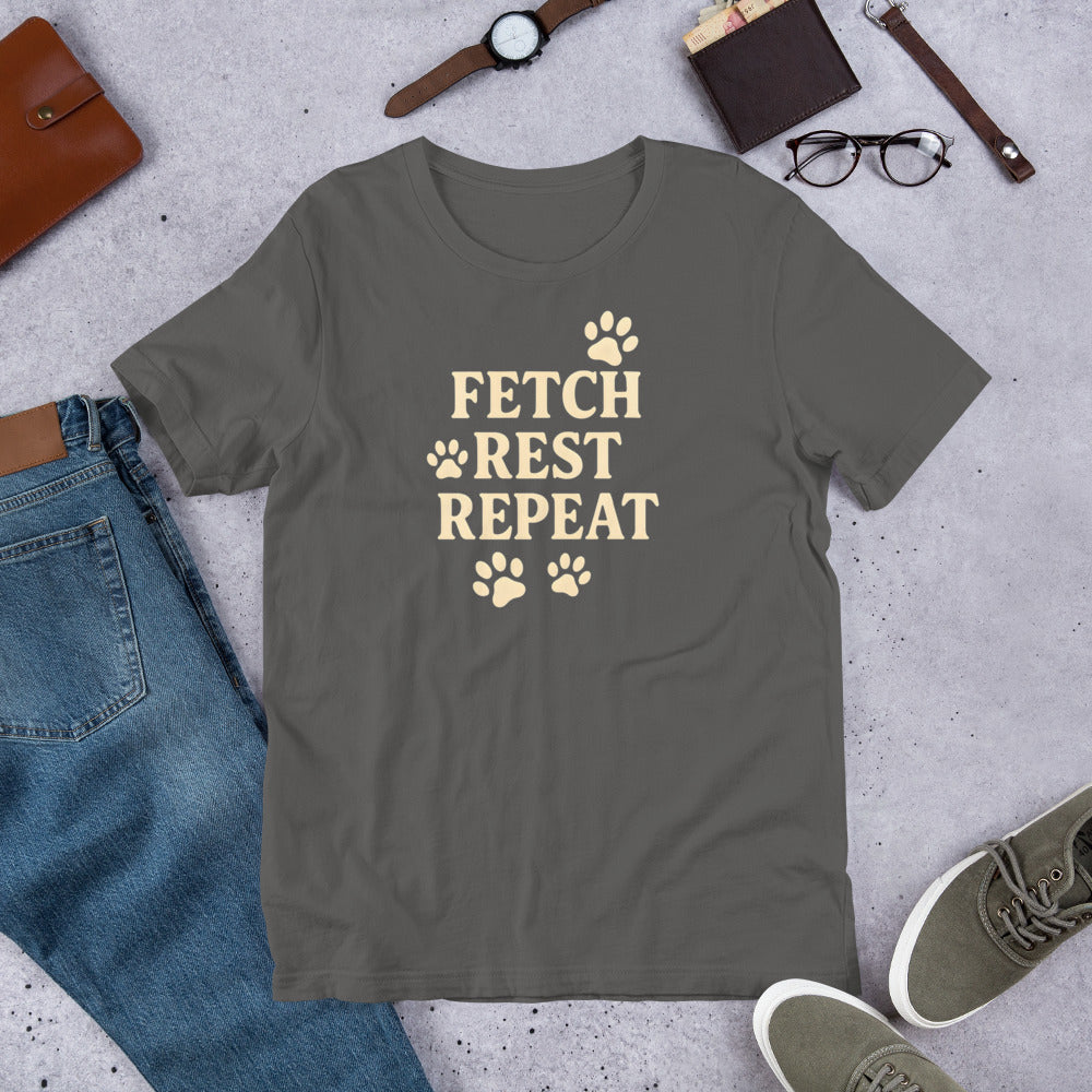 "Fetch Rest Repeat" - Fun Labrador T-Shirt Gray t-shirt with 'Fetch Rest Repeat' text on a concrete surface with jeans, shoes, and accessories.