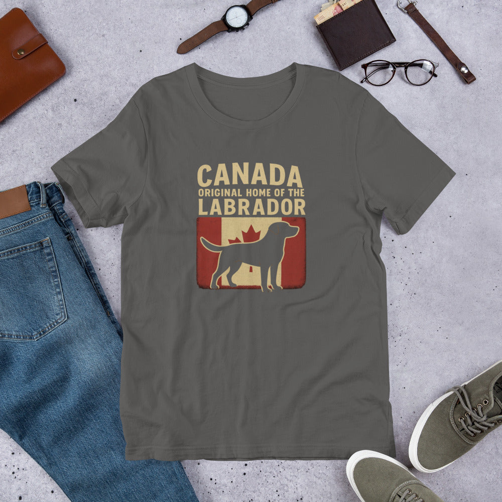 Canada – Original Home of the Labrador - Fun Labrador Tee Gray t-shirt with Labrador and Canada text on a concrete surface with jeans, shoes, and accessories.