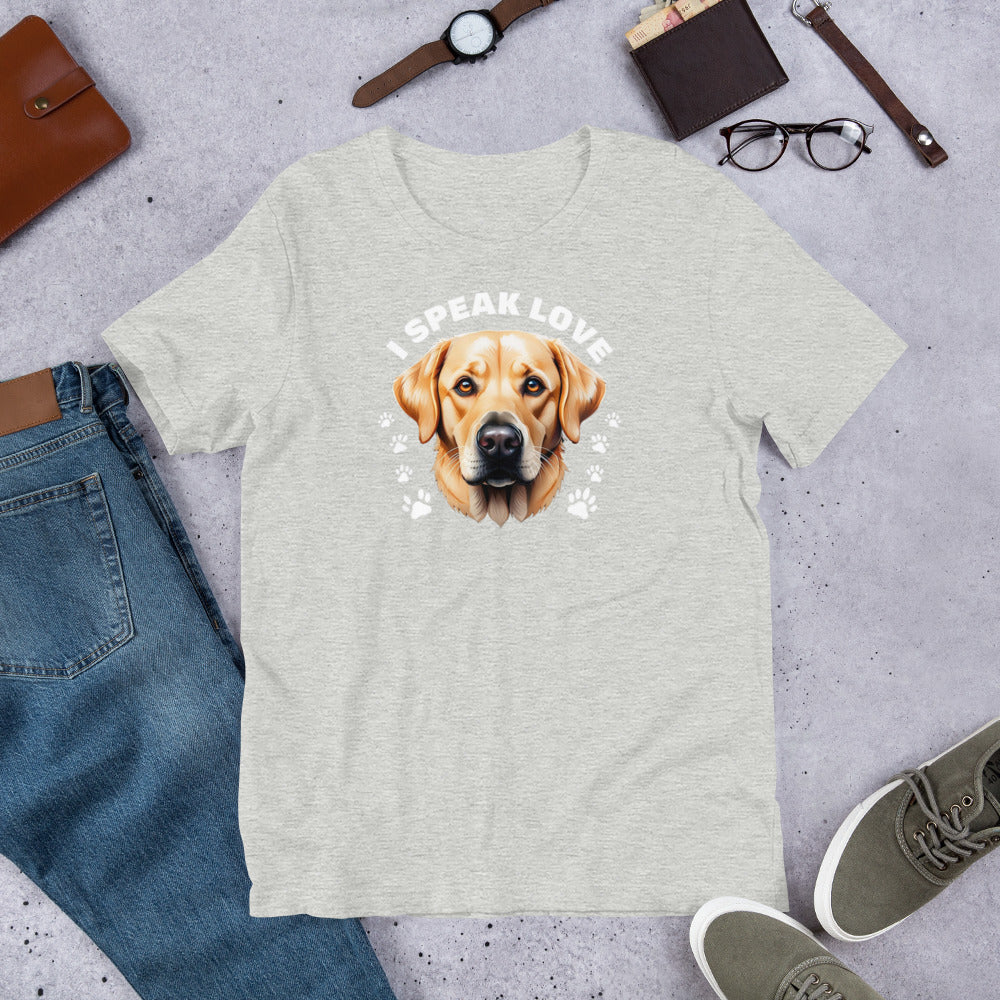 "I Speak Love" - Fun Labrador T-Shirt Gray t-shirt with a dog graphic and 'I Speak Love' text, surrounded by jeans, shoes, and accessories on a concrete surface.