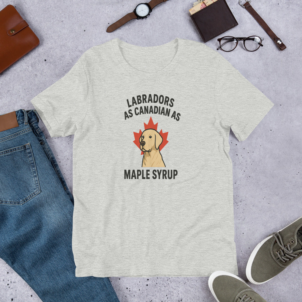 Labradors – As Canadian as Maple Syrup - Fun Labrador Tee Gray t-shirt with a Labrador graphic and text on a concrete surface with jeans, shoes, and accessories.