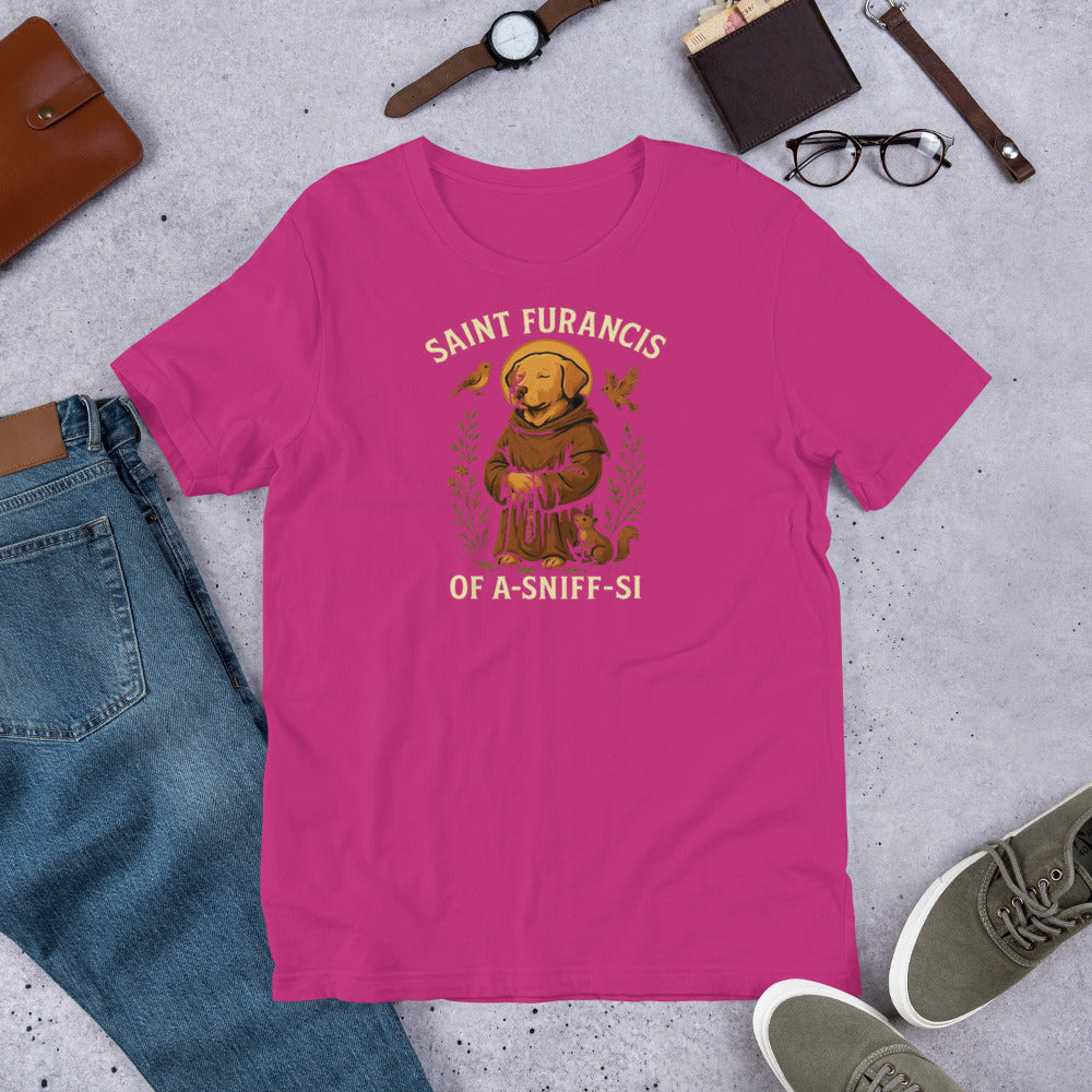 "Saint Furances Of A-Sniff-Si " – Fun Labrador T-Shirt Pink t-shirt with a graphic design on a gray surface with accessories around