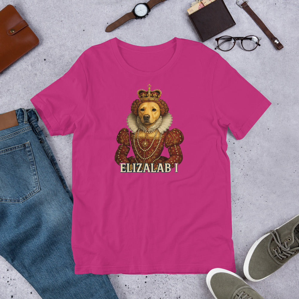 "Elizalab 1 " – Fun Labrador T-Shirt Pink t-shirt with a bear wearing a crown and 'ELIZALAB I' text, surrounded by jeans, shoes, and accessories on a gray surface.