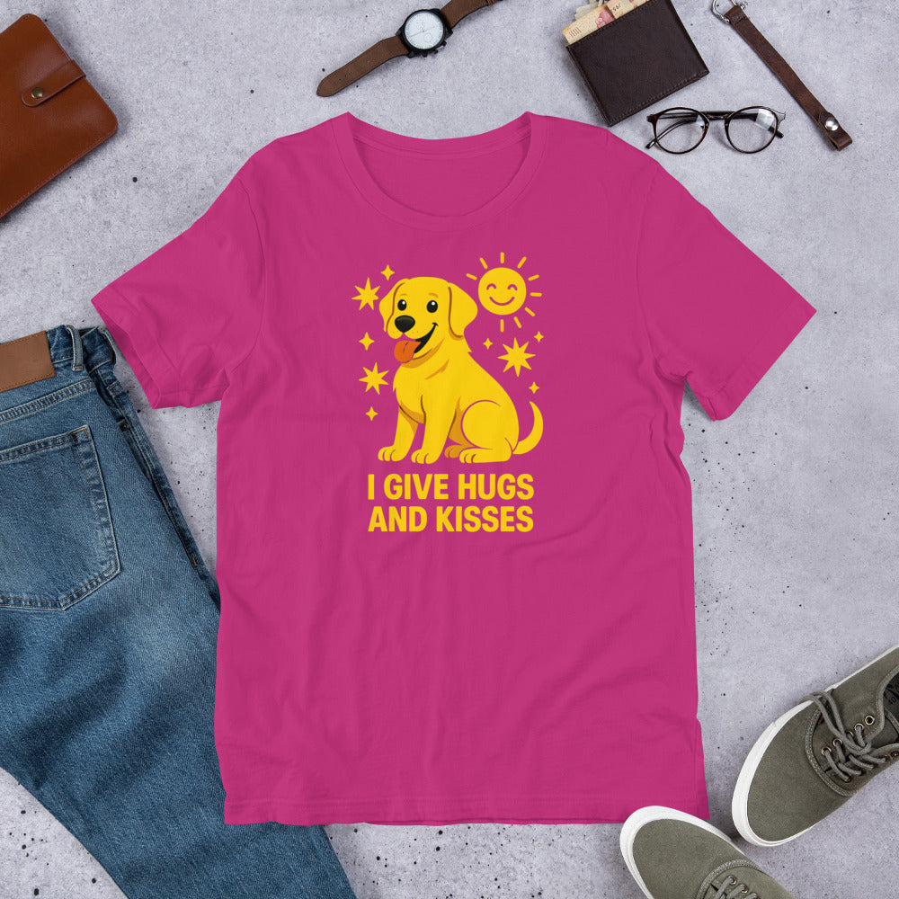 "I Give Hugs And Kisses " – Fun Labrador T-Shirt Pink t-shirt with a yellow dog graphic and text 'I give hugs and kisses' on a gray surface with casual items.