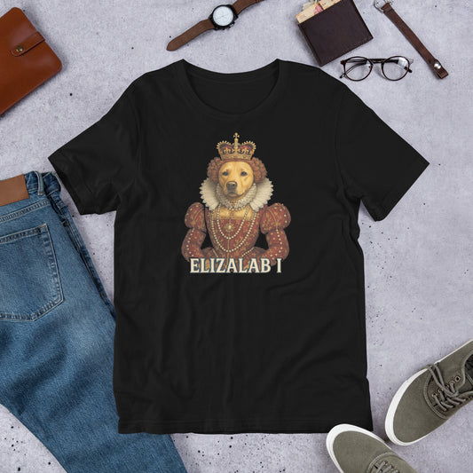 "Elizalab 1 " – Fun Labrador T-Shirt Black t-shirt with a lion wearing a crown and 'ELIZALAB I' text, surrounded by jeans, shoes, and accessories on a concrete surface.