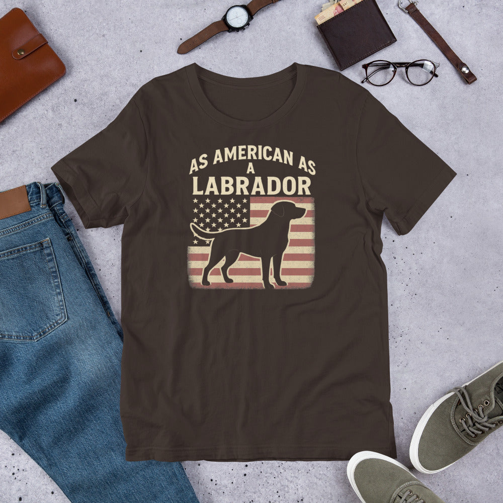 As American As A Labrador - Fun Labrador Tee Brown t-shirt with 'As American as a Labrador' graphic on a concrete surface with jeans, shoes, and accessories.