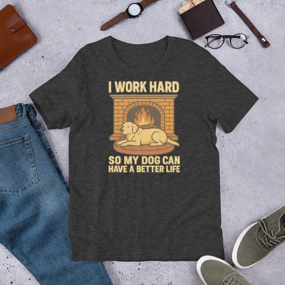 "I work Hard So My Dog Can Have A Better Life" - Fun Labrador T-Shirt Dark gray t-shirt with a graphic and text on a concrete surface with casual items around.