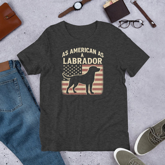 As American As A Labrador - Fun Labrador Tee Dark gray t-shirt with 'As American as a Labrador' graphic on a concrete surface with jeans, shoes, and accessories.