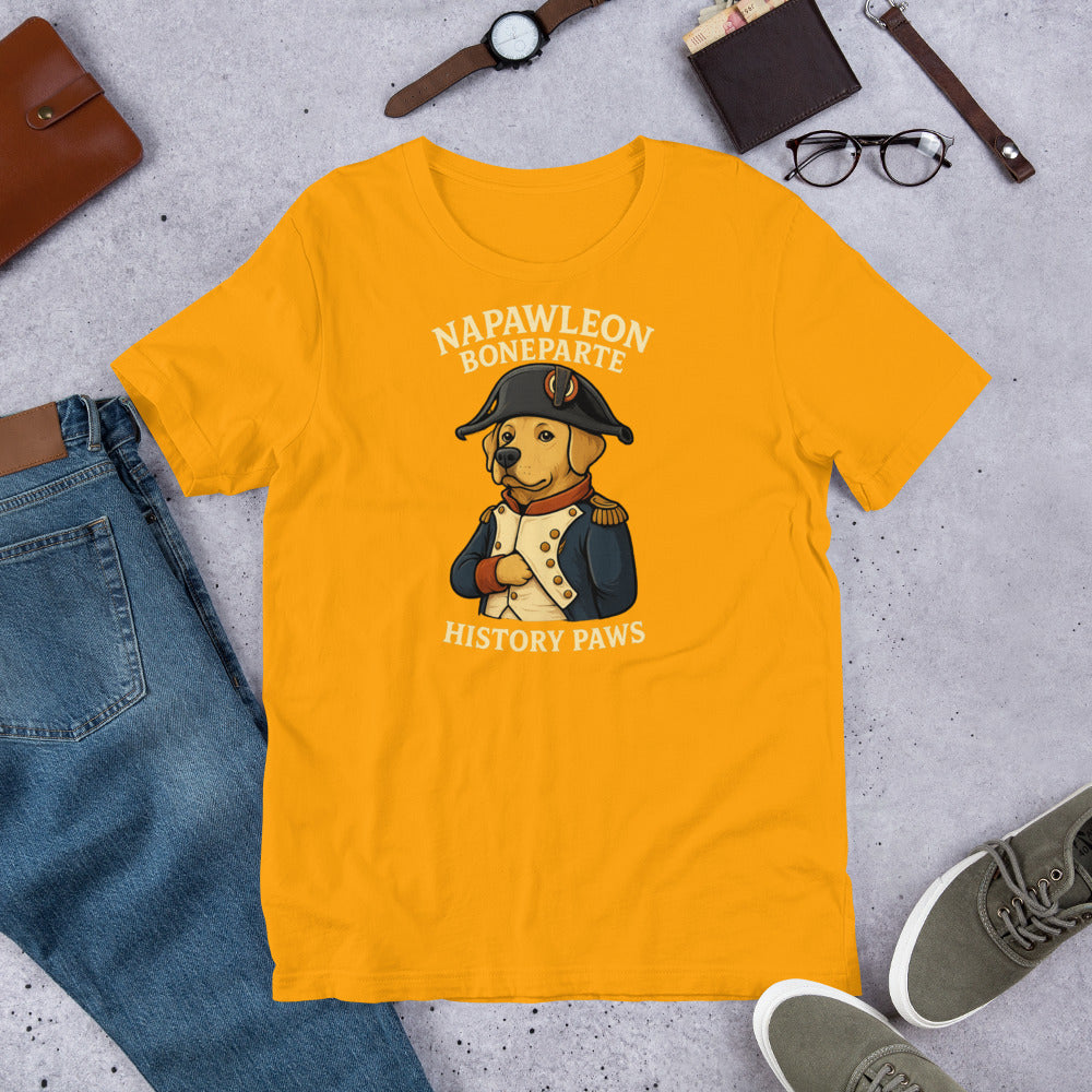 "Napawleon Boneparte" -Fun Labrador T-Shirt  Yellow t-shirt with a cartoon dog in a Napoleon outfit on a gray surface with jeans, shoes, and accessories.