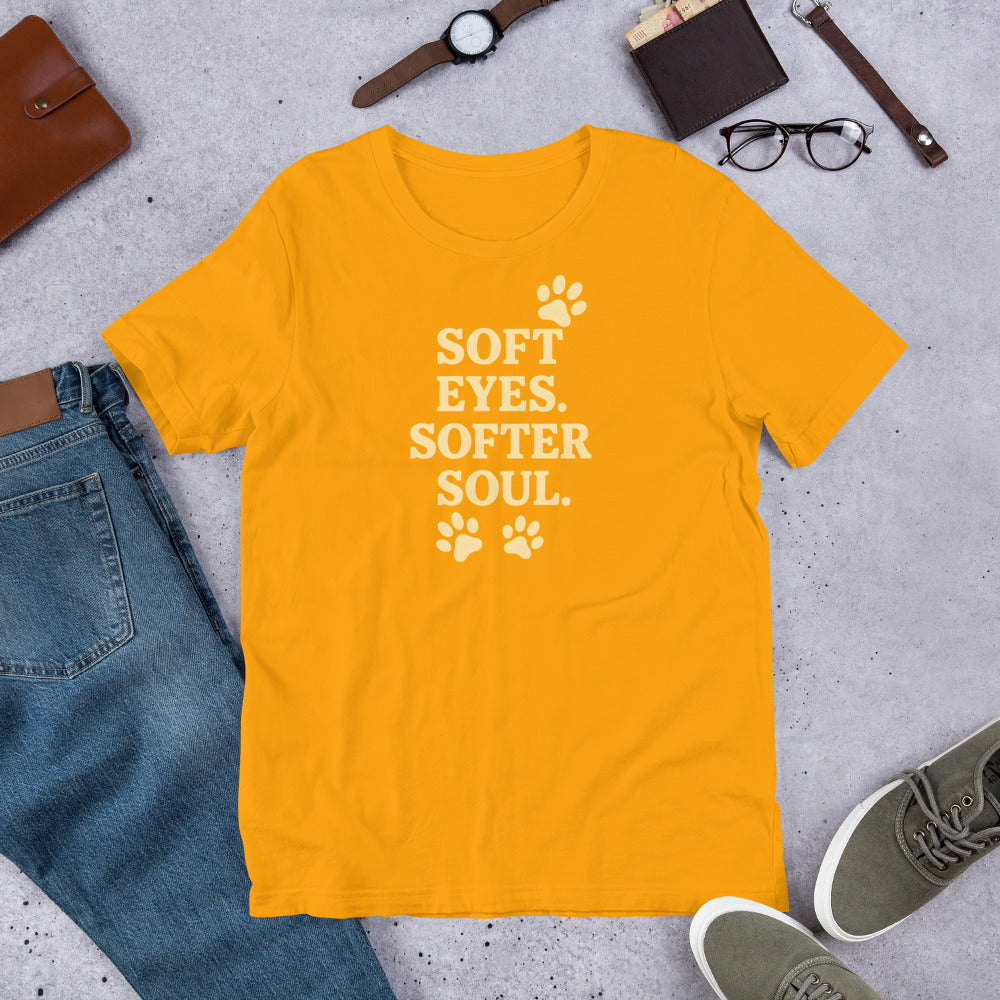 "Soft Eyes Softer Soul" - Fun Labrador T-Shirt Yellow t-shirt with 'Soft Eyes. Softer Soul.' text on a gray surface with jeans, shoes, and accessories.