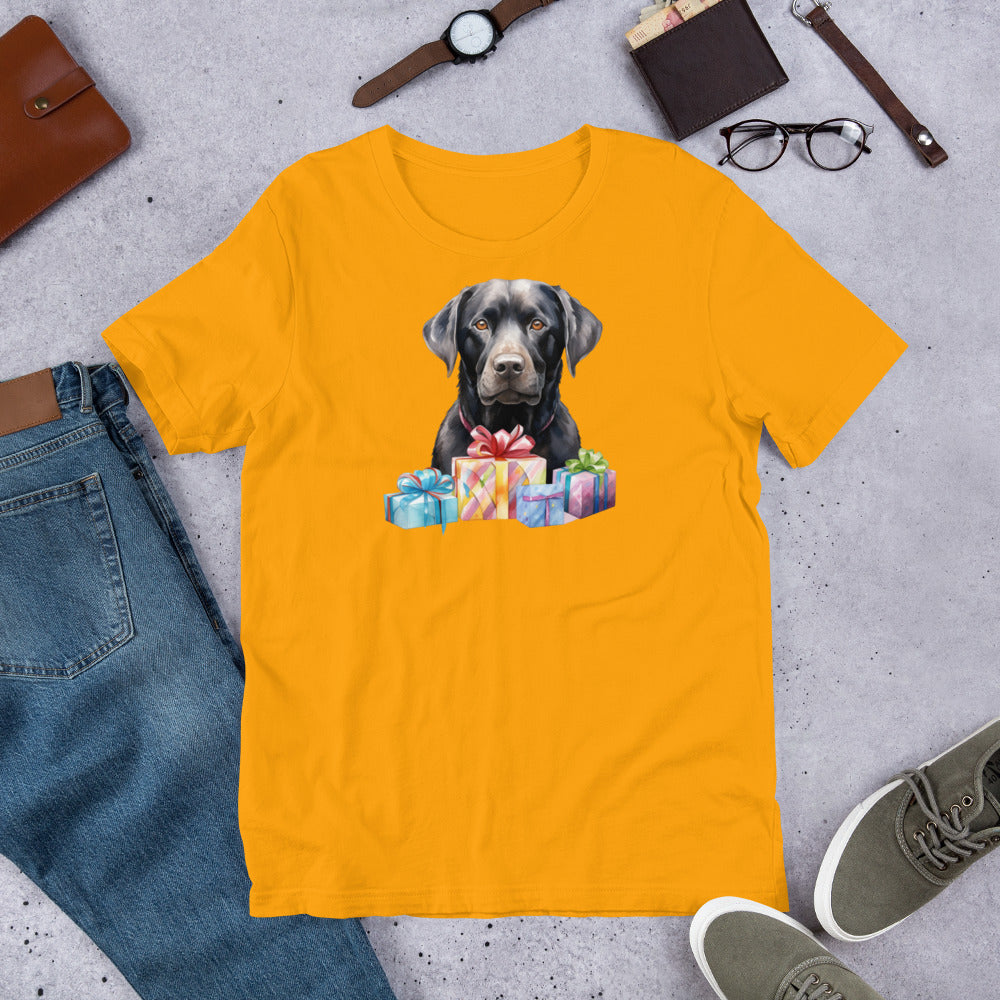 "Black Lab With Presents " – Fun Labrador T-Shirt Yellow t-shirt with a dog and gift design on a gray surface with jeans, shoes, and accessories.