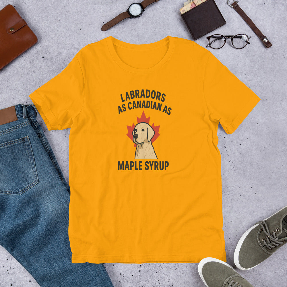 Labradors – As Canadian as Maple Syrup - Fun Labrador Tee Yellow t-shirt with Labrador and maple syrup graphic on a concrete surface with jeans, shoes, and accessories.