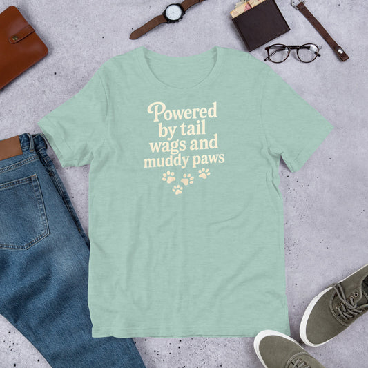 "Powered By Tail Wags And Muddy Paws" - Fun Labrador T-Shirt Mint green t-shirt with text and paw prints on a concrete surface with jeans, shoes, and accessories.