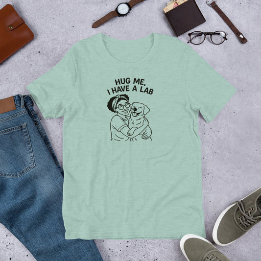 " Hug Me I Have A Lab" - Fun Labrador T-Shirt  Mint green t-shirt with a graphic and text 'Hug Me, I Have a Lab' on a concrete surface with jeans, shoes, and accessories.