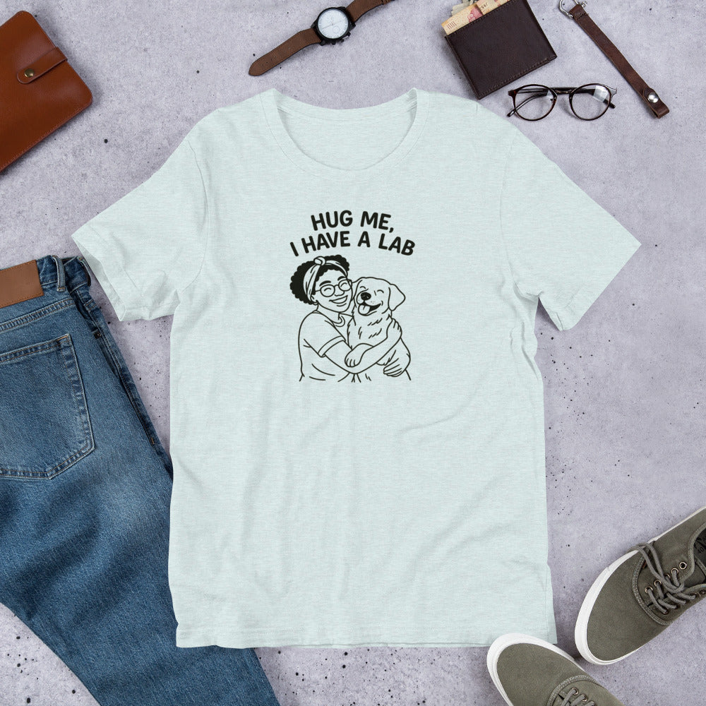 " Hug Me I Have A Lab" - Fun Labrador T-Shirt Light blue t-shirt with 'Hug Me, I Have a Lab' graphic on a gray surface with jeans, shoes, and accessories.