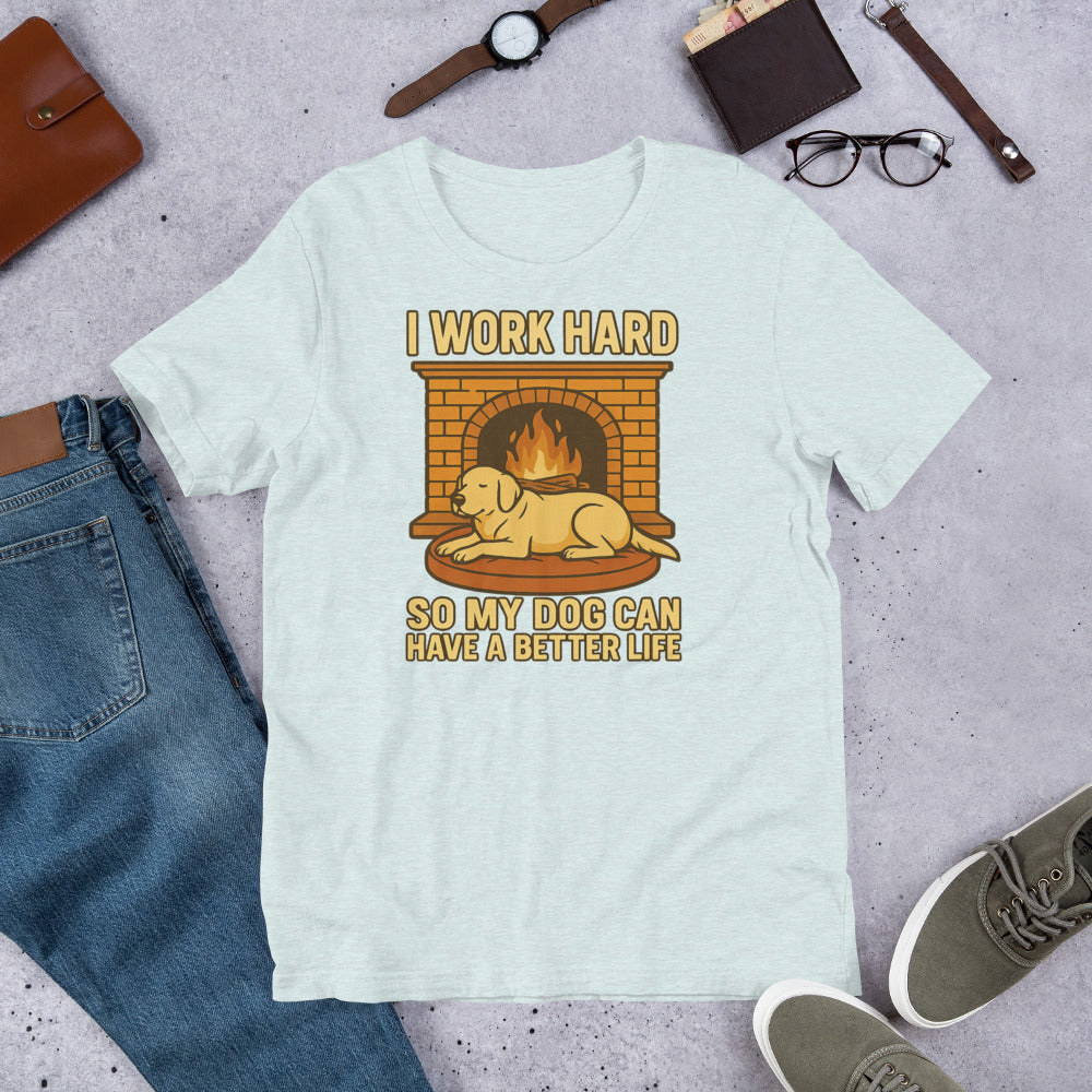 "I Work Hard So My Dog Can Have A Better Life " - Fun Labrador T-Shirt Light blue t-shirt with a graphic of a dog by a fireplace and text 'I work hard so my dog can have a better life' on a gray surface with jeans, shoes, and a wallet.