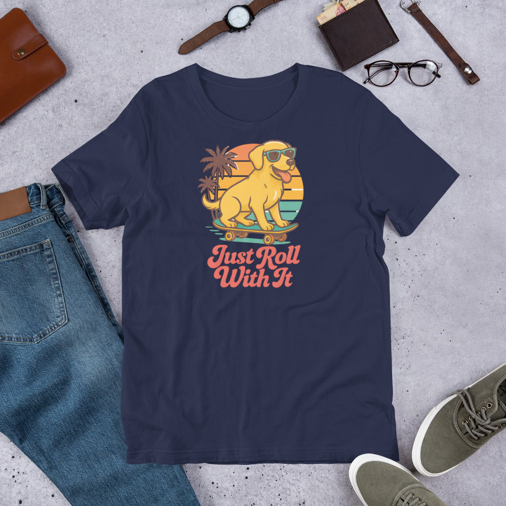 "Just Roll With It "  - Yellow Lab – Fun Labrador T-Shirt Navy blue t-shirt with a graphic of a dog on roller skates and 'Just Roll With It' text, surrounded by casual items on a concrete surface.