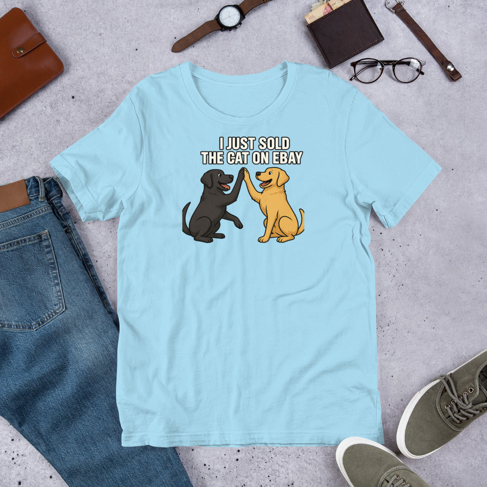 "I Just Sold The Cat On eBay" - Fun Labrador T-Shirt Light blue t-shirt with dog graphic and text on a concrete surface with jeans, shoes, and accessories.