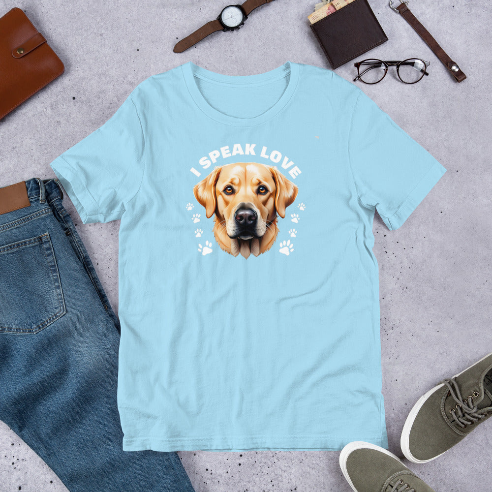 "I Speak Love" - Fun Labrador T-Shirt Light blue t-shirt with a dog graphic and 'I speak love' text, placed on a concrete surface with jeans, shoes, and accessories.