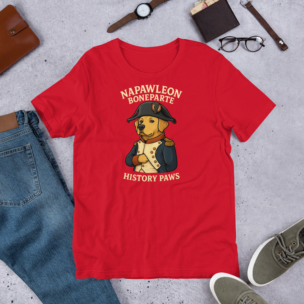 "Napawleon Boneparte" -Fun Labrador T-Shirt Red t-shirt with a bear in historical attire graphic and text on a gray surface with casual items.