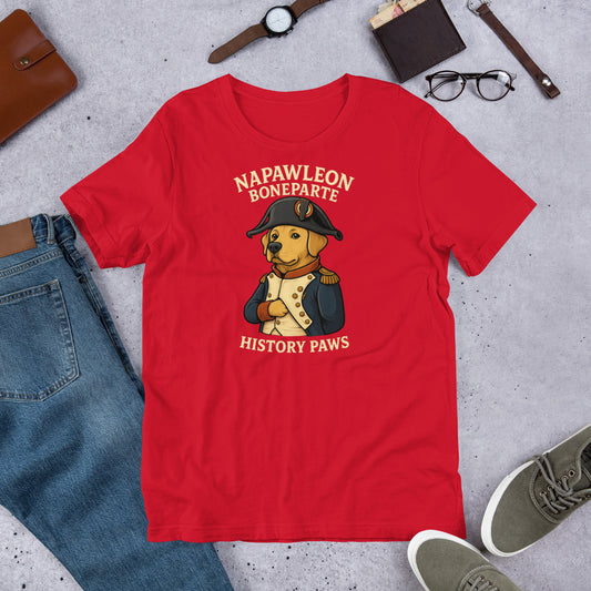 "Napawleon Boneparte" -Fun Labrador T-Shirt Red t-shirt with a bear in historical attire graphic and text on a gray surface with casual items.