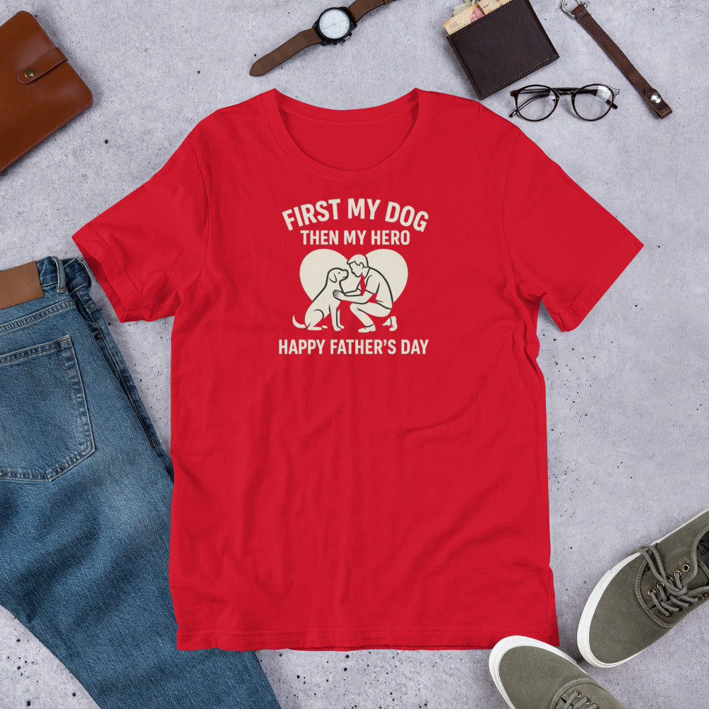 "First My Dog  Then My Hero" - Fun Labrador T-Shirt Red t-shirt with a graphic and text on a gray surface with casual items around