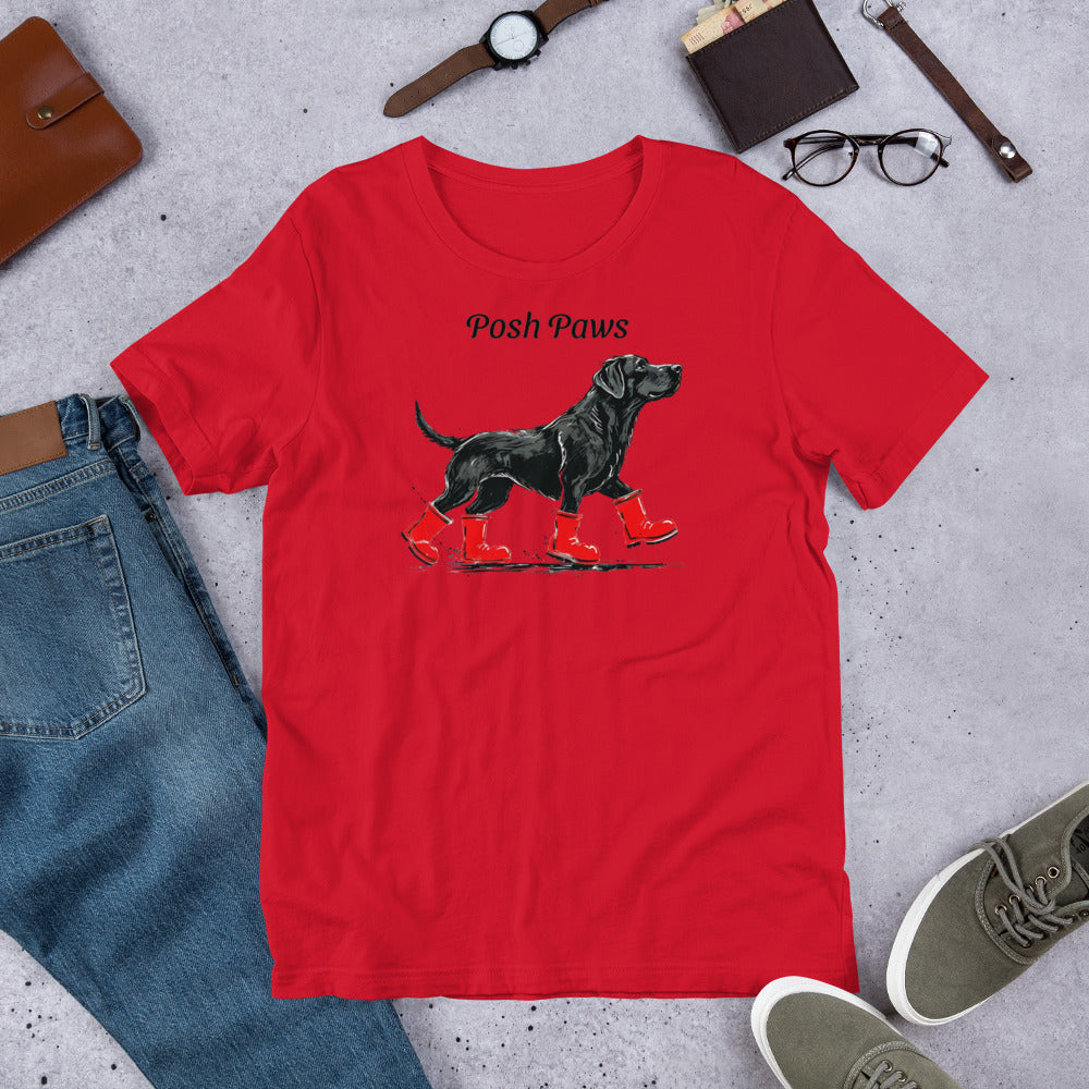 "Posh Paws" - Fun Labrador T-Shirt Red t-shirt with a dog graphic and 'Posh Paws' text on a concrete surface with casual items.