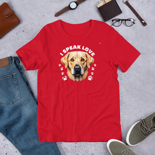 "I Speak Love" - Fun Labrador T-Shirt Red t-shirt with a dog graphic and 'I Speak Love' text on a gray surface with casual items.